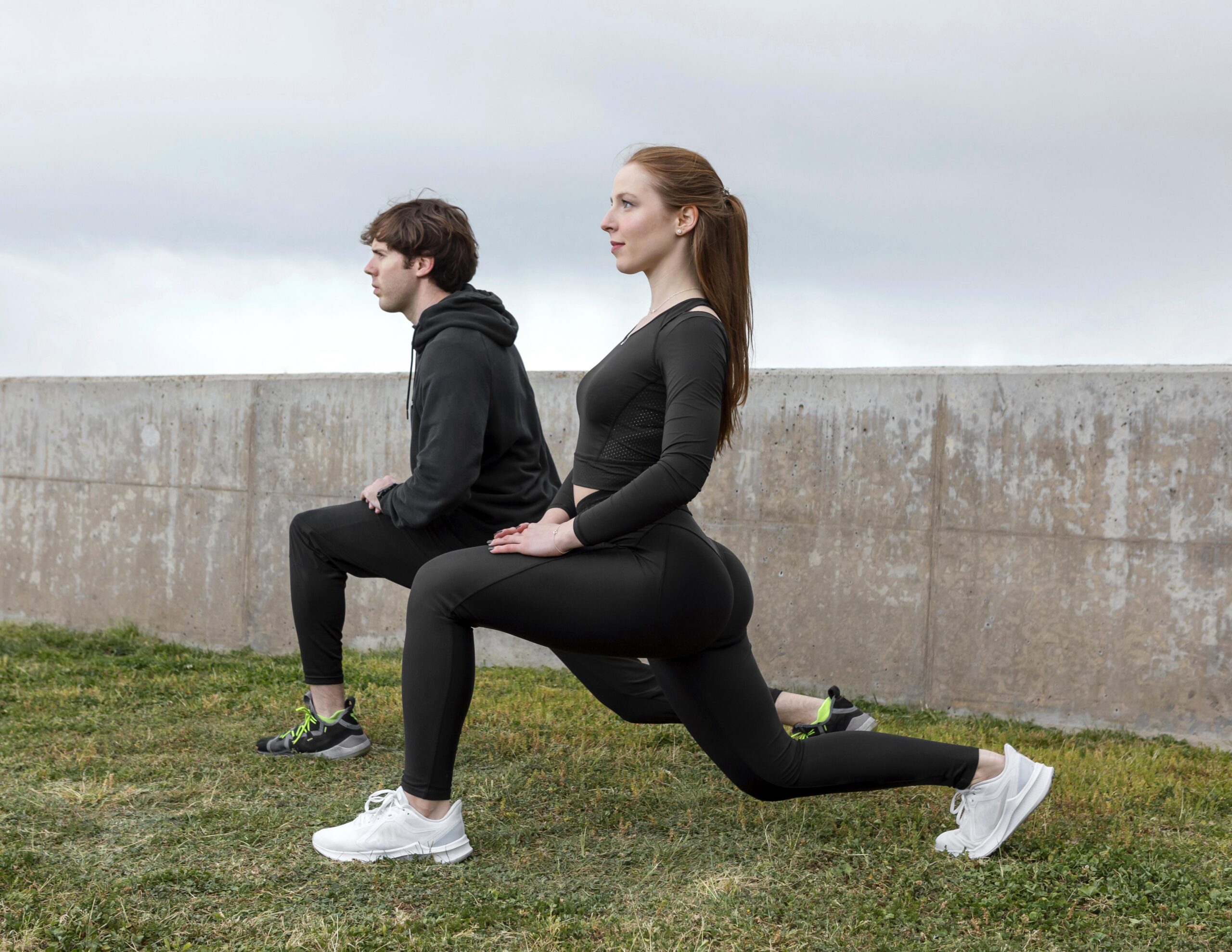 Hybrid athlete performing outdoor pull-ups on gym equipment to master relative bodyweight strength.