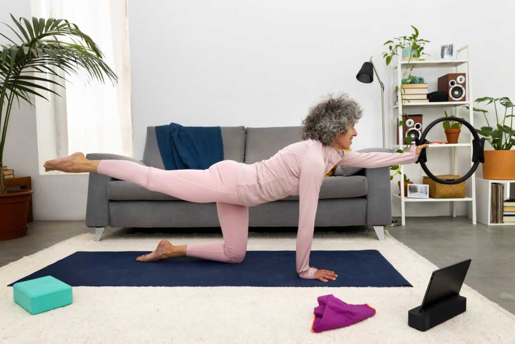 A woman over 40 performing a bird dog for total body mobility and core stabilization.